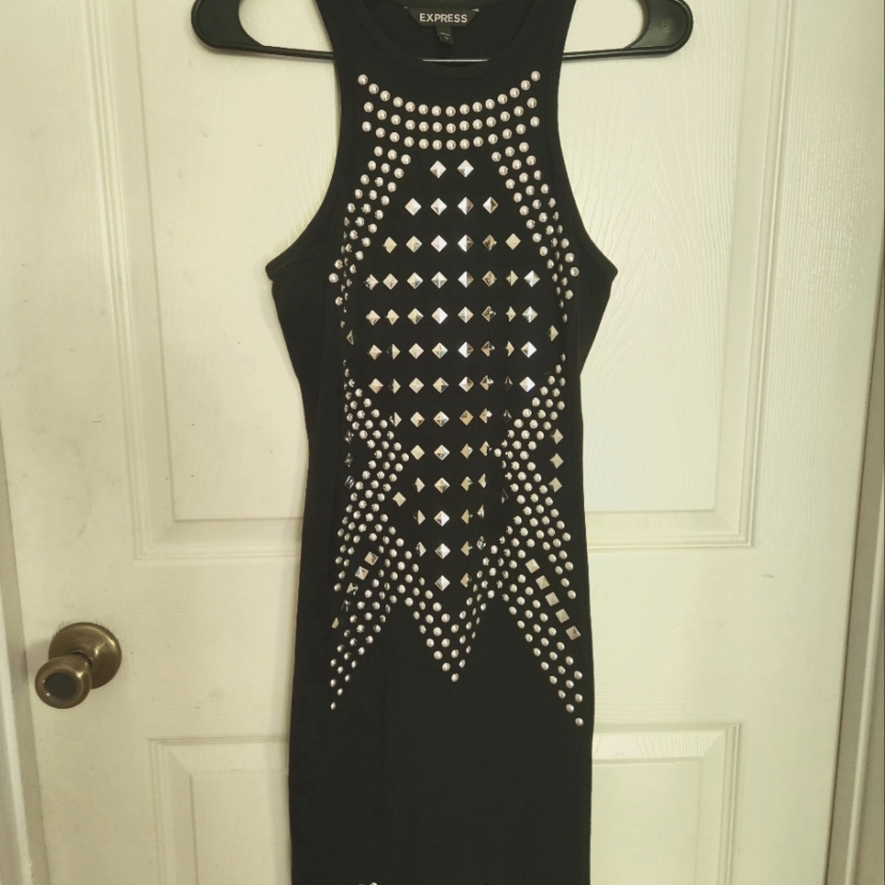 Black knee-length dress with silver studs on the front.
